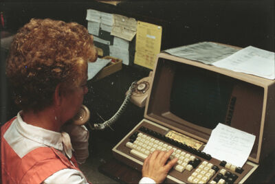 League Member Working at a Computer Slide