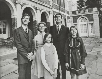 governor and mrs. dunn and children admire governor's mansion photograph, 1971 (image)