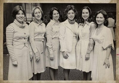 unidentified epsilon tau chapter member on patterned couch photograph, c. 1977 (image)