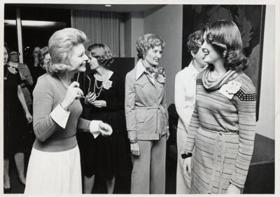 unidentified epsilon tau chapter member on patterned couch photograph, c. 1977 (image)