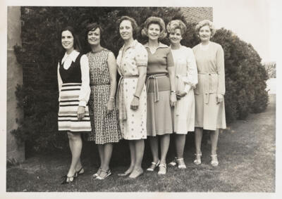 unidentified epsilon tau chapter member on patterned couch photograph, c. 1977 (image)