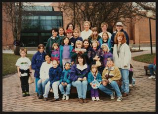 Eta Psi Chapter Members with Children at Easter Egg Hunt Photograph