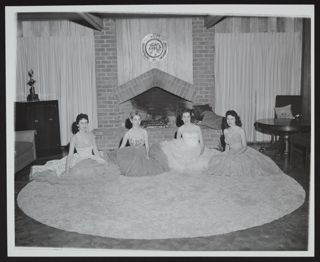 Four Gamma Alpha Chapter Queens in Front of Fireplace Photograph, 1958