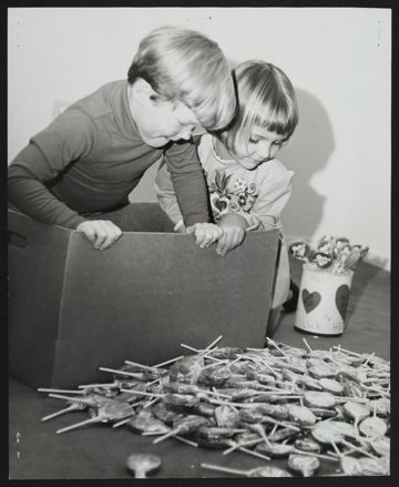 Gordon Cross and Vickie Brown Examining Alpha Phi Lollipops Photograph, 1972