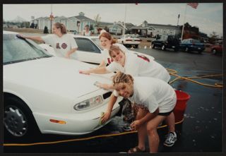 Four Theta Psi Chapter Members Washing Car Photograph, c. 2000