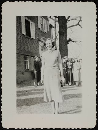 Unidentified Rho Chapter Member Smiling in Front of Chapter House Photograph, c. 1940s