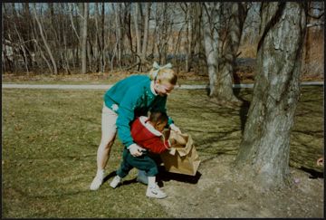 Unidentified Beta Omega Chapter Member and Child Gathering Easter Eggs Photograph
