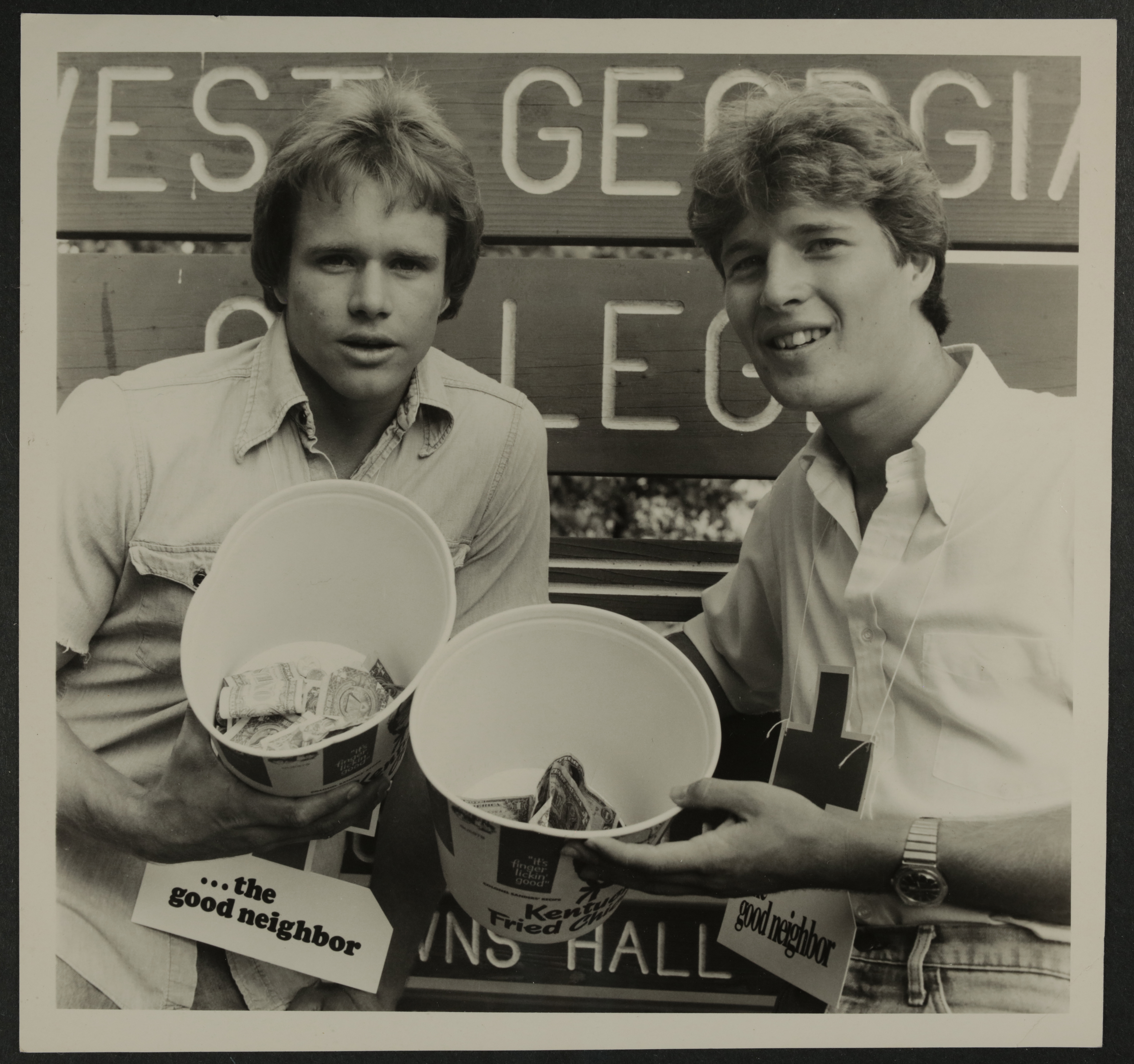 Two Eta Sigma Chapter Members Collecting Money in KFC Buckets Photograph