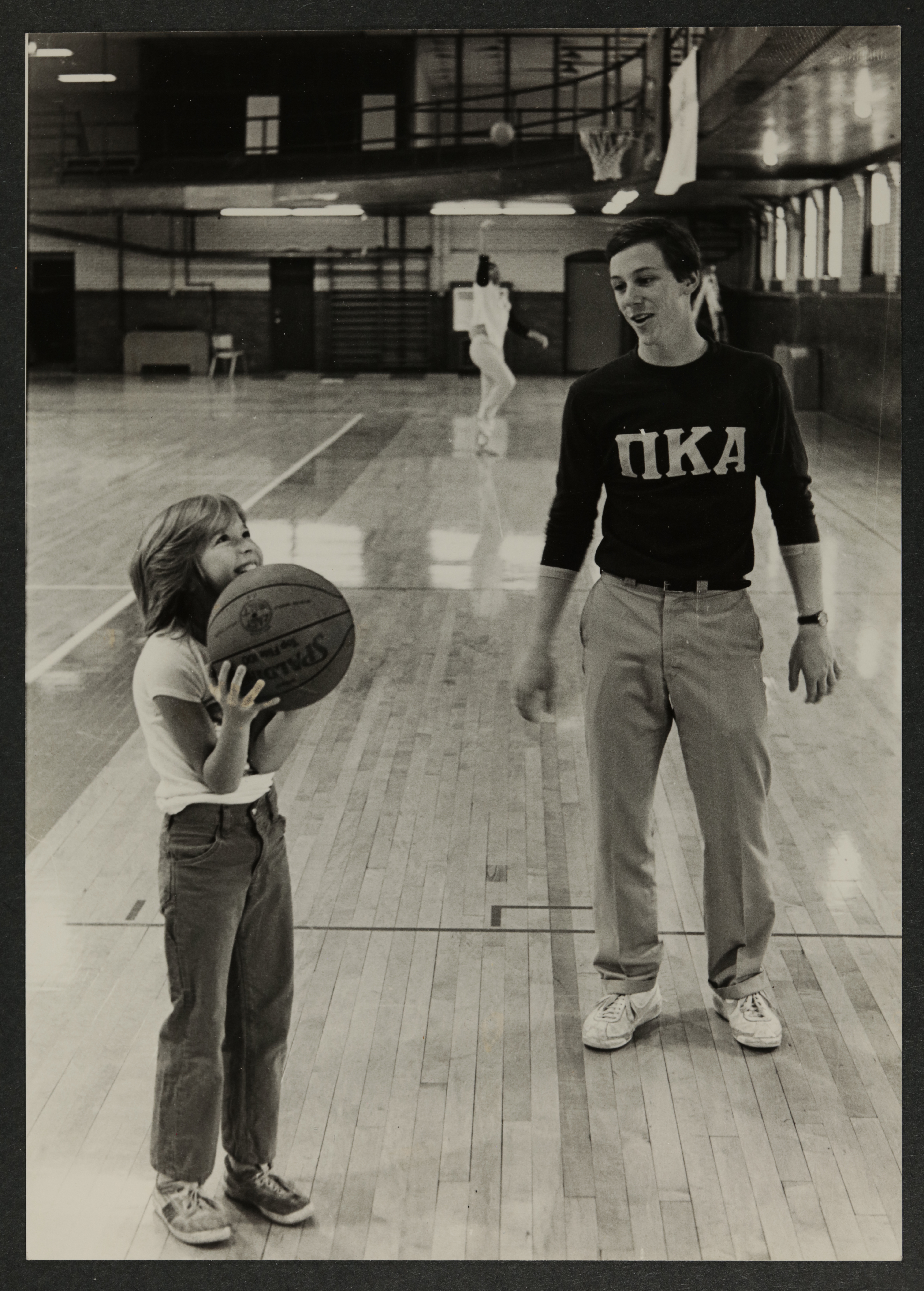 John Feole Encouraging Child with Basketball Photograph, c. 1981-1985