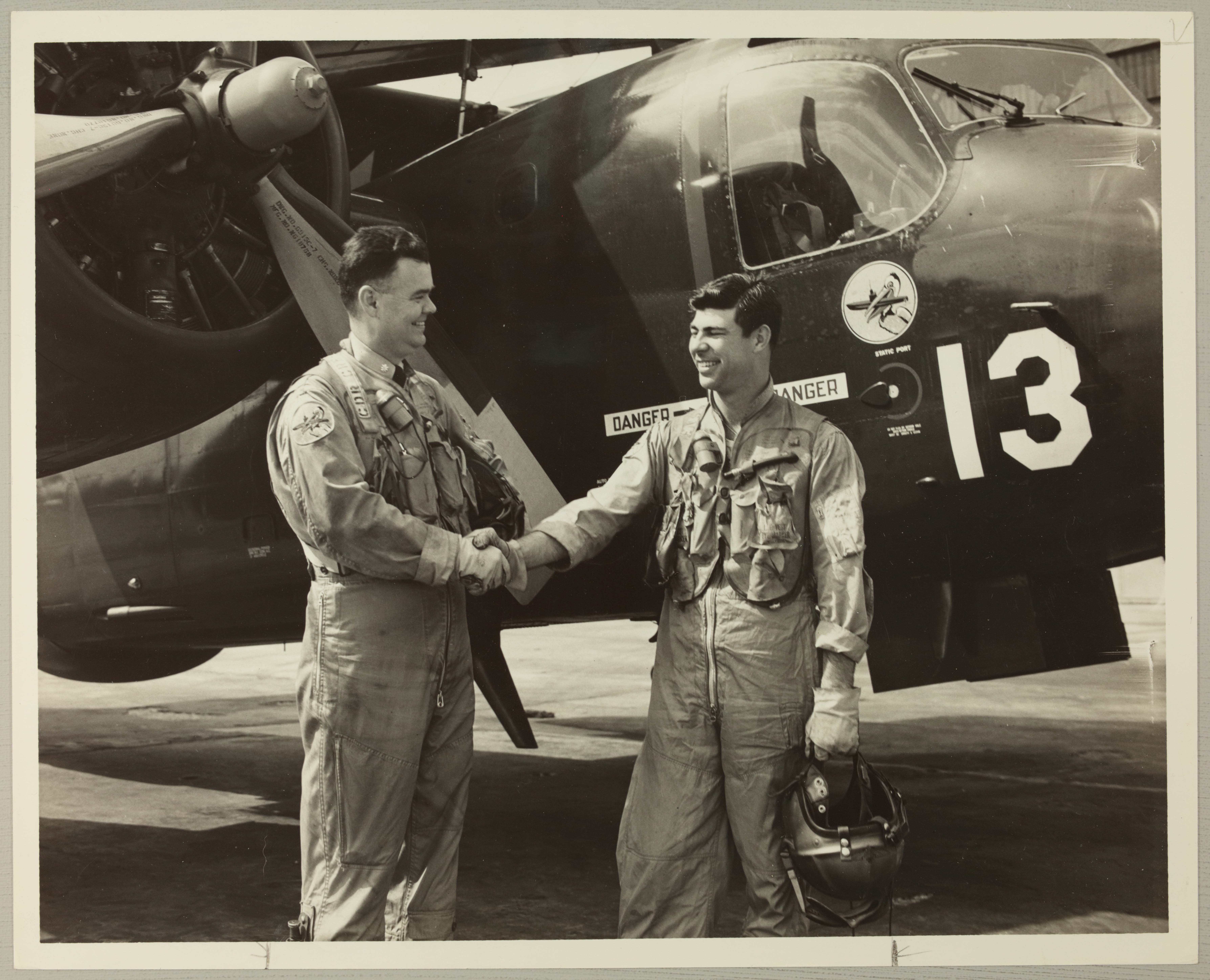 Edmund Creekmore and Carl Austin in Front of Plane Photograph, April 7, 1955