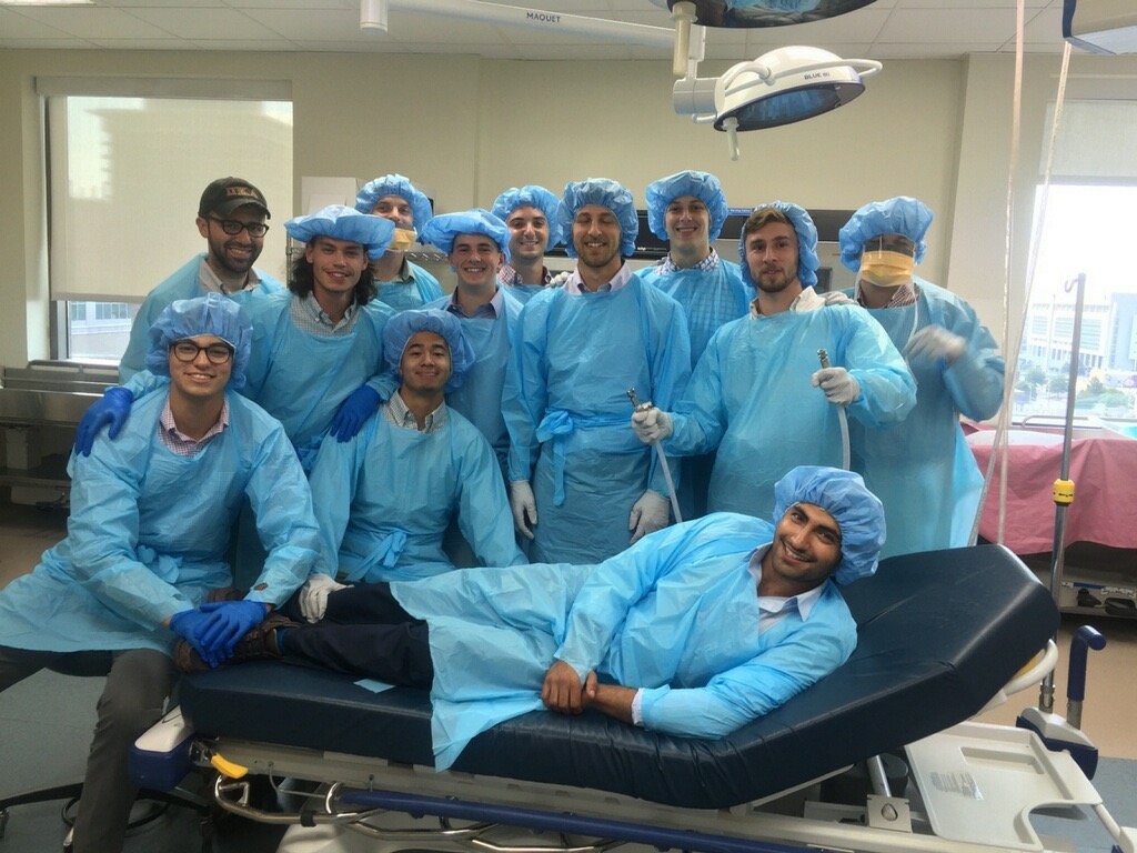 Twelve Lambda Chi Chapter Members Dressed in Isolation Gowns Photograph