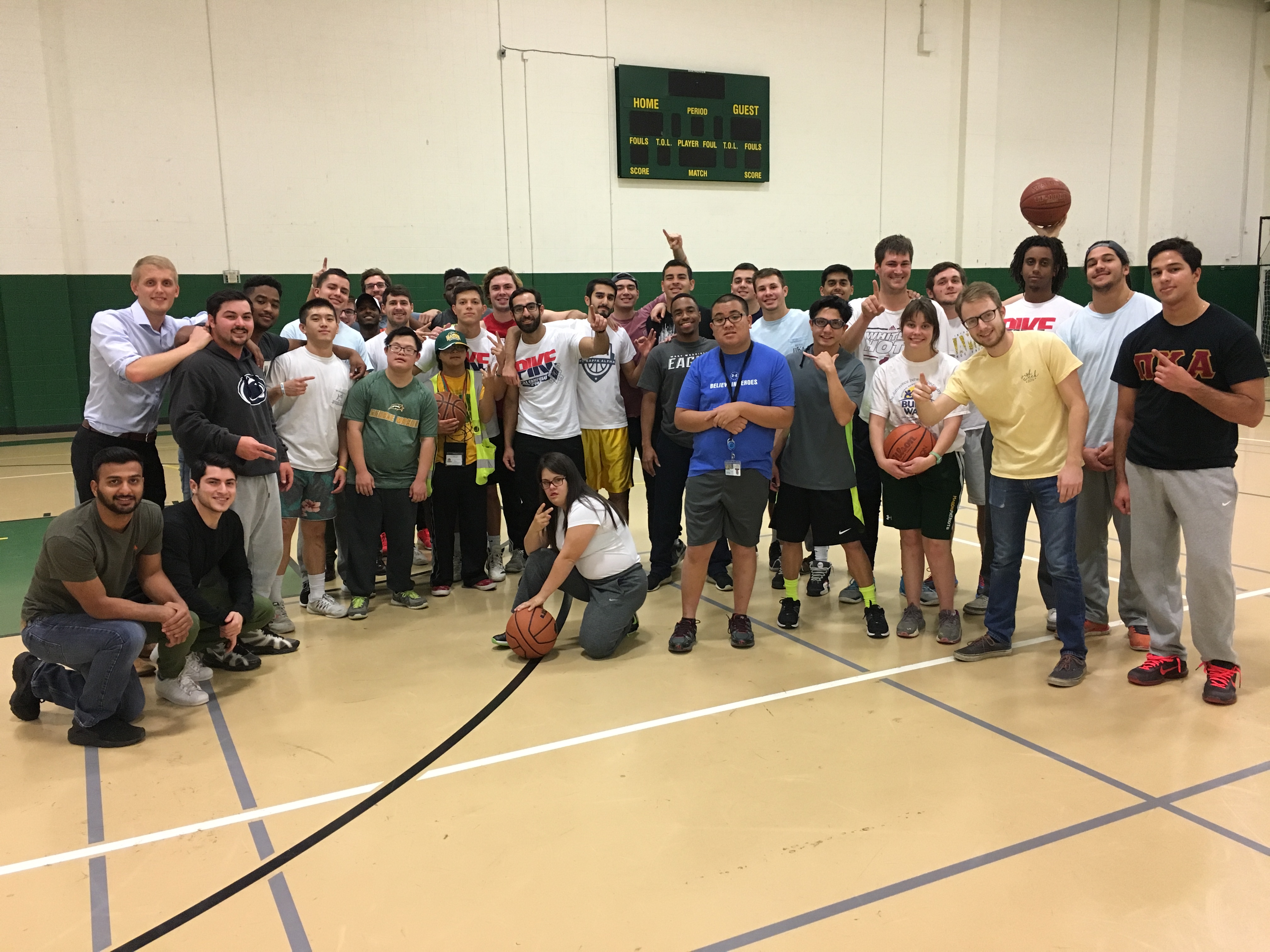 Kappa Theta Chapter Members Play Club Basketball with Other Students Photograph