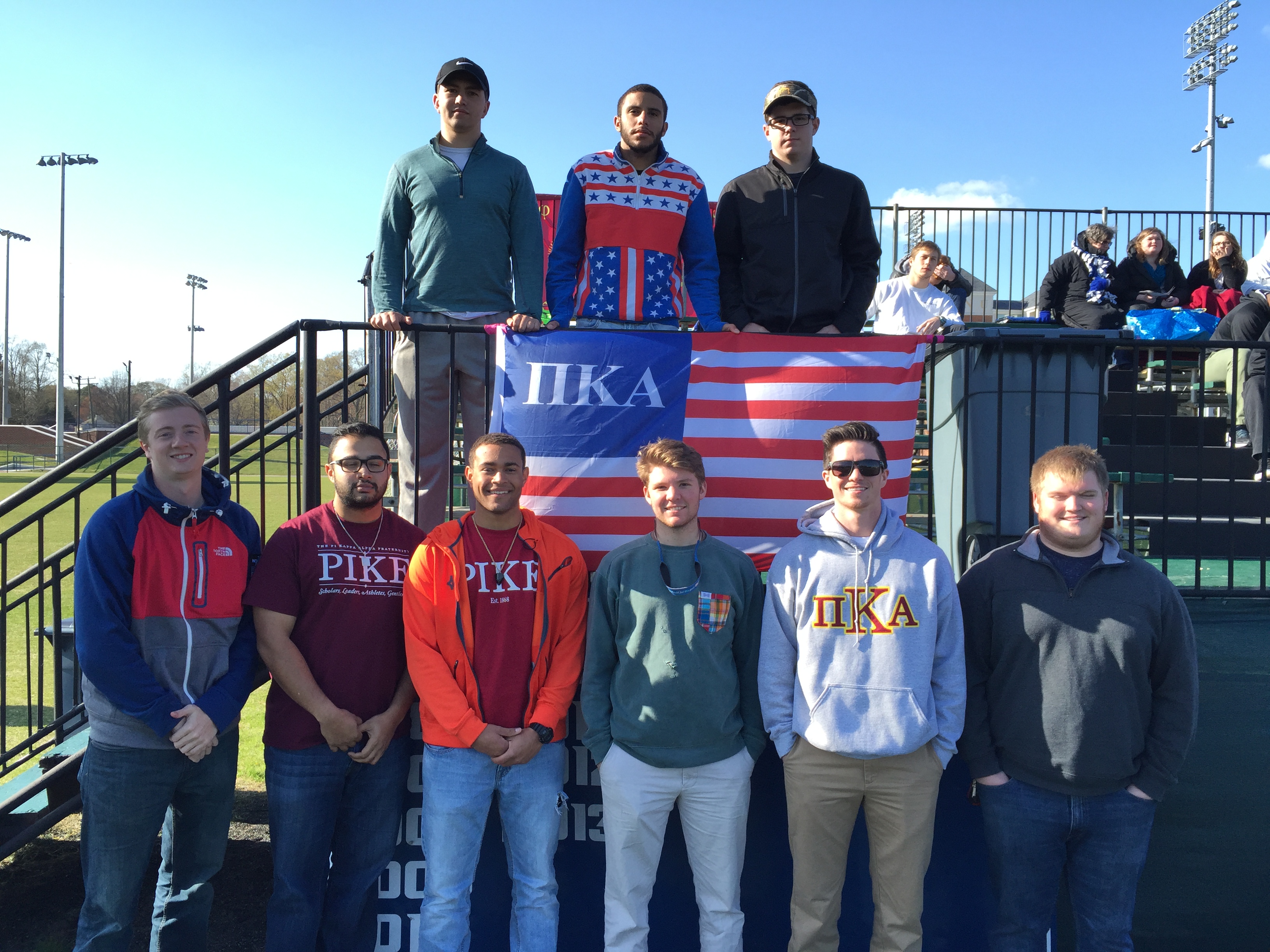 Nine Mu Rho Chapter Members at a Sports Game Photograph