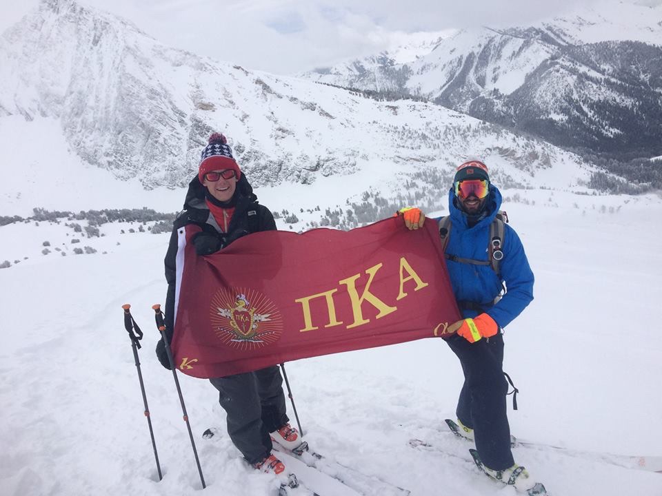 Two Lambda Delta Pikes Skiing Hold Up A Pike Flag Photograph