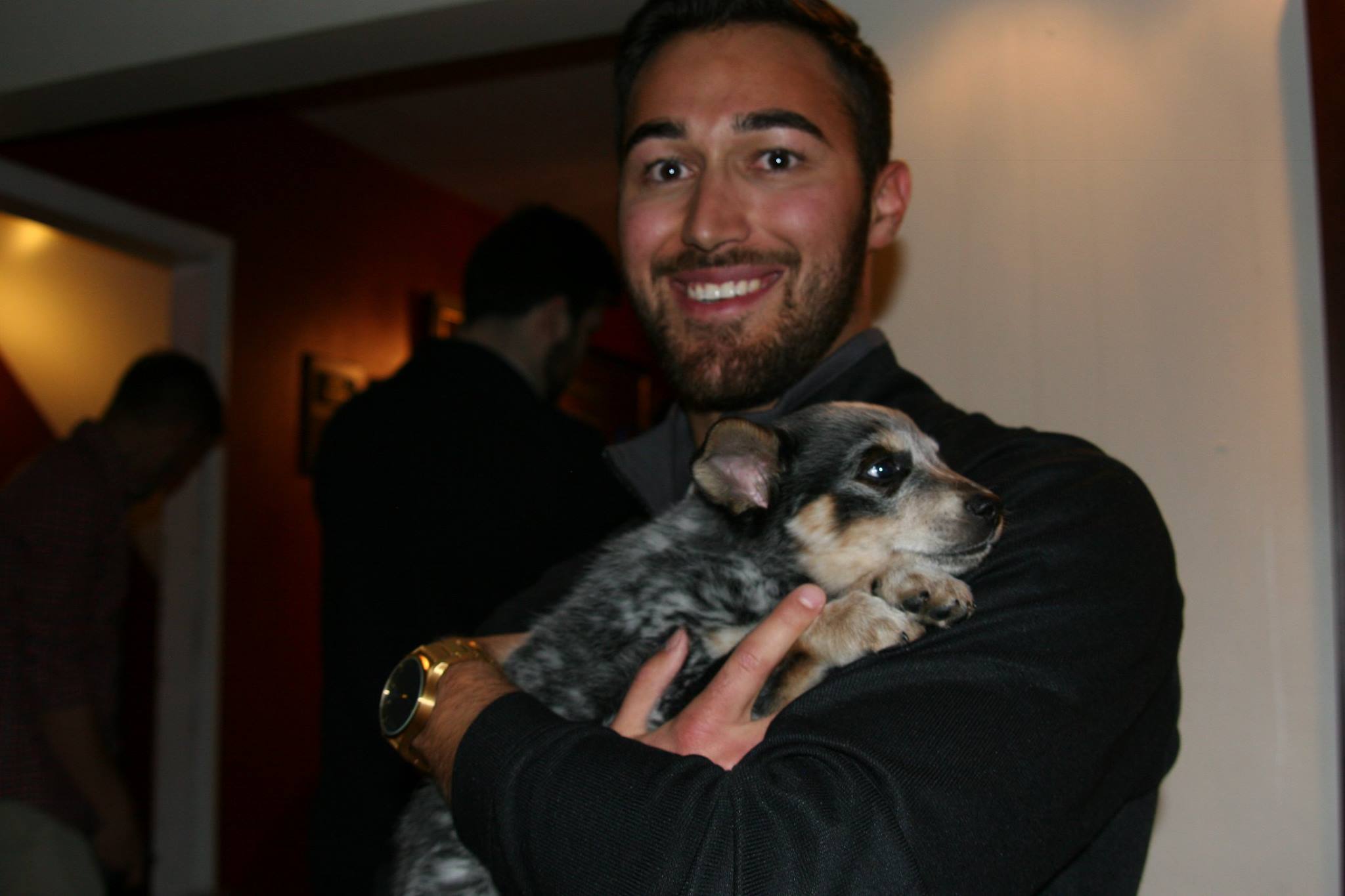 An Unidentified Alpha Tau Chapter Member Holding A Puppy Photograph