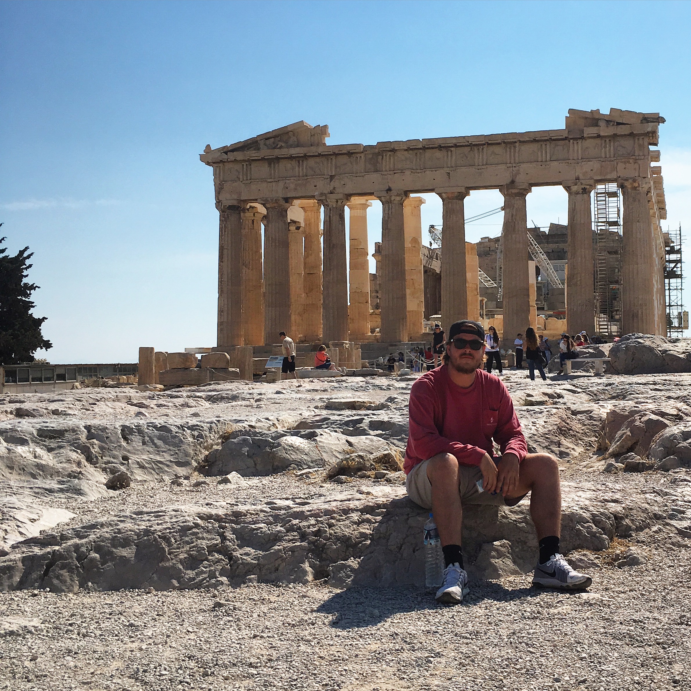 An Eta Epsilon Chapter Member In Front of Building Ruins Photograph
