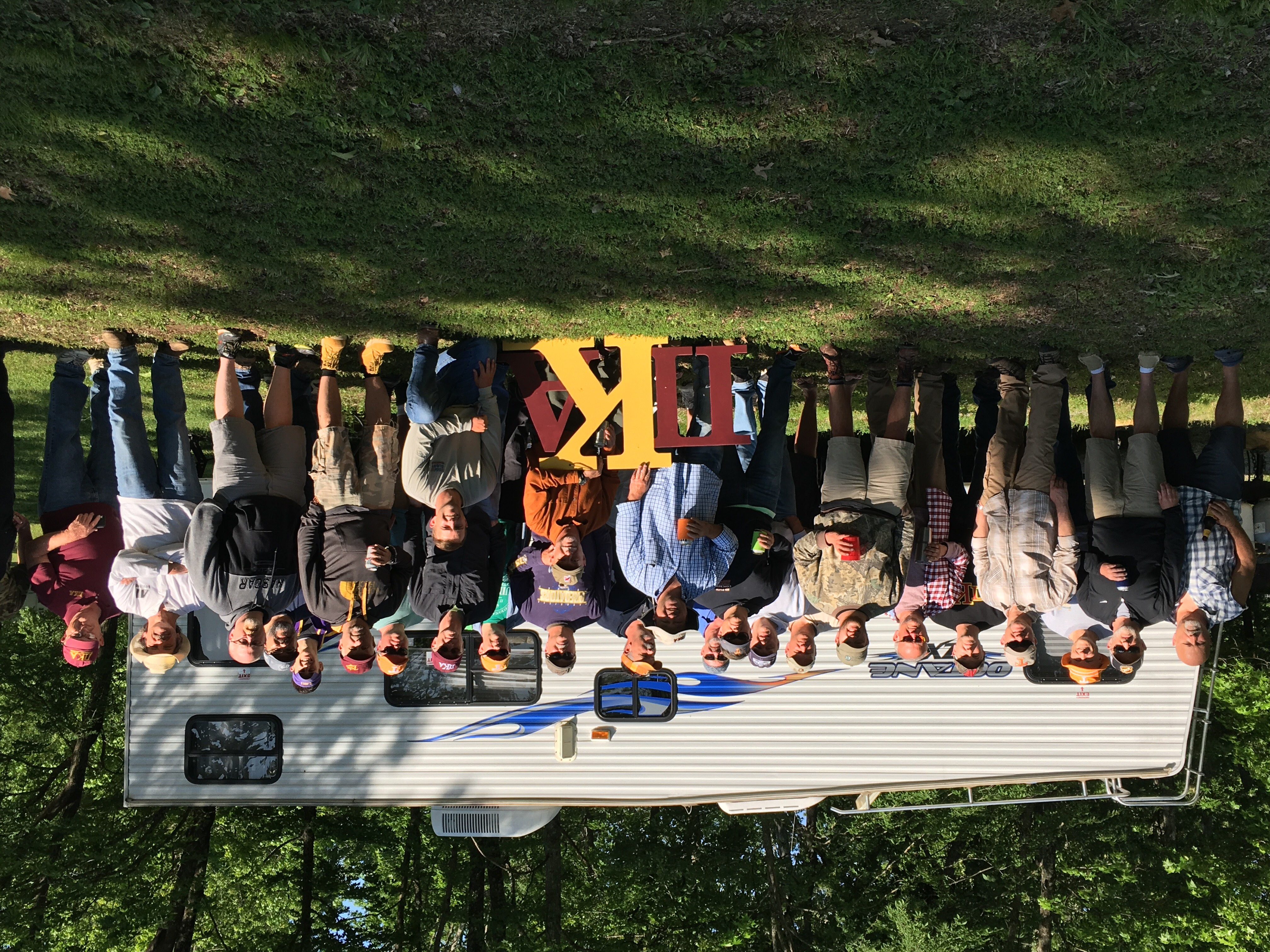 Eta Tau Alumni Stand Outside of a Camping Trailer Photograph, 2017