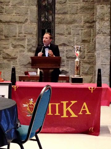 An Unidentified Pike Speaking at a Podium Behind an Award Photograph