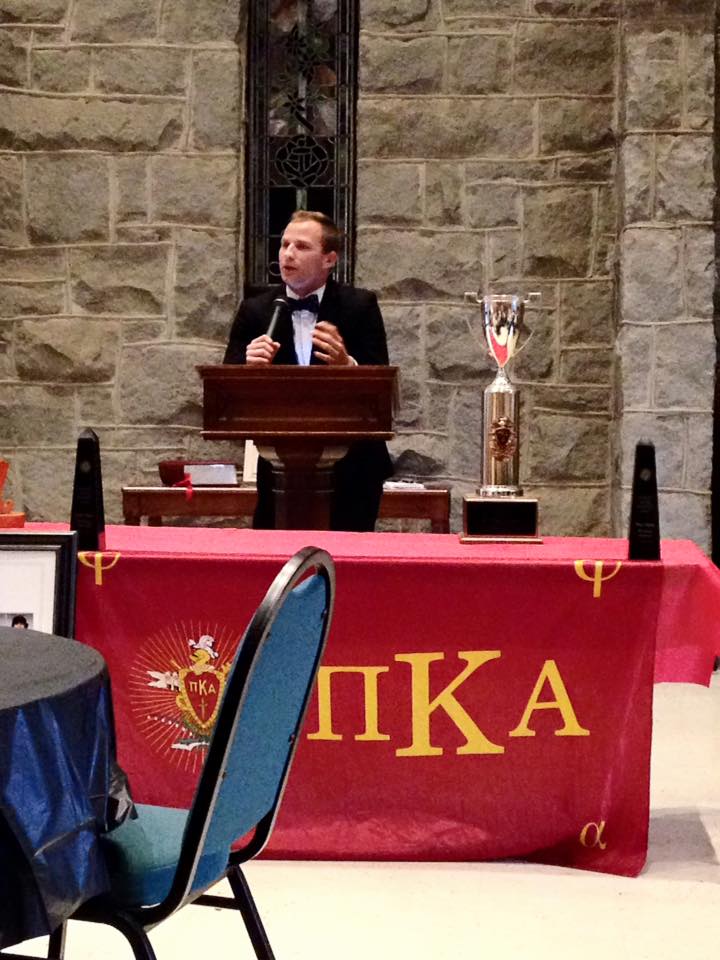 An Unidentified Pike Speaking at a Podium Behind an Award Photograph