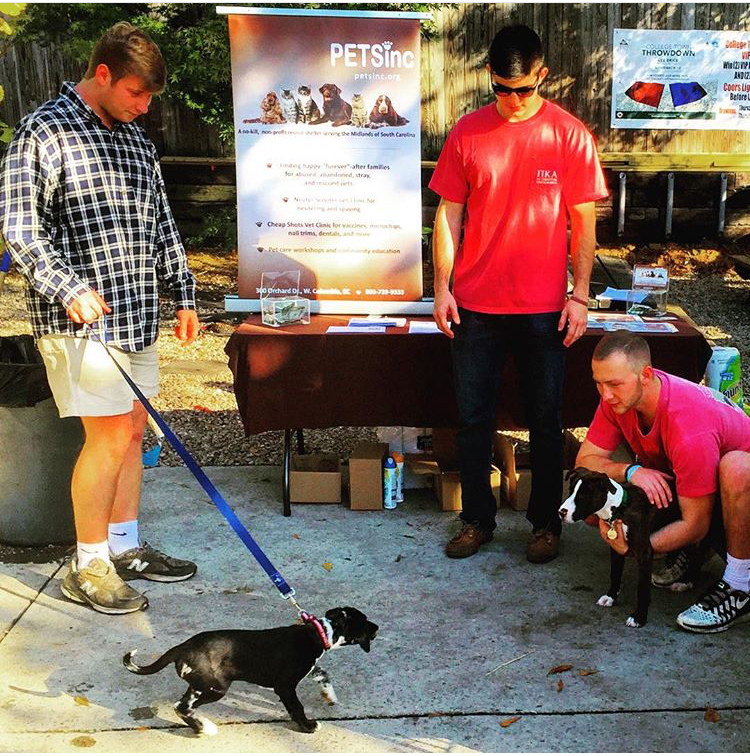 Three Unidentified Xi Chapter Members At Pikes For Puppies Event Photograph