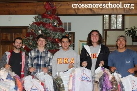 Five Iota Psi Chapter Members Holding Dry Cleaning Bags Photograph
