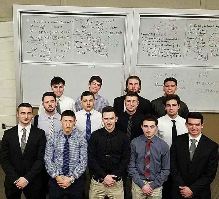 Thirteen Lambda Gamma Chapter Members In Front of A Whiteboard Photograph