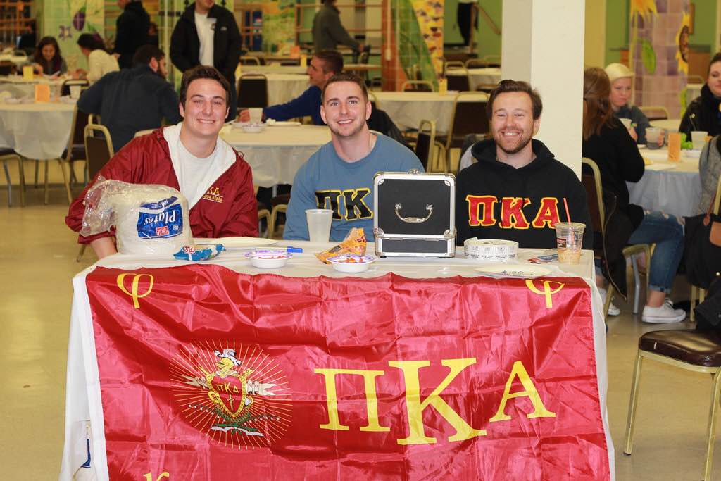 Three Theta Mu Chapter Members Table At A Food Event Photograph, 2015