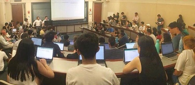 Students Listen To A Presentation In A Lecture Hall Photograph