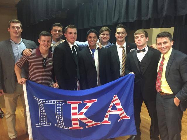 Nine Eta Omicron Chapter Members With a PiKA Flag Photograph