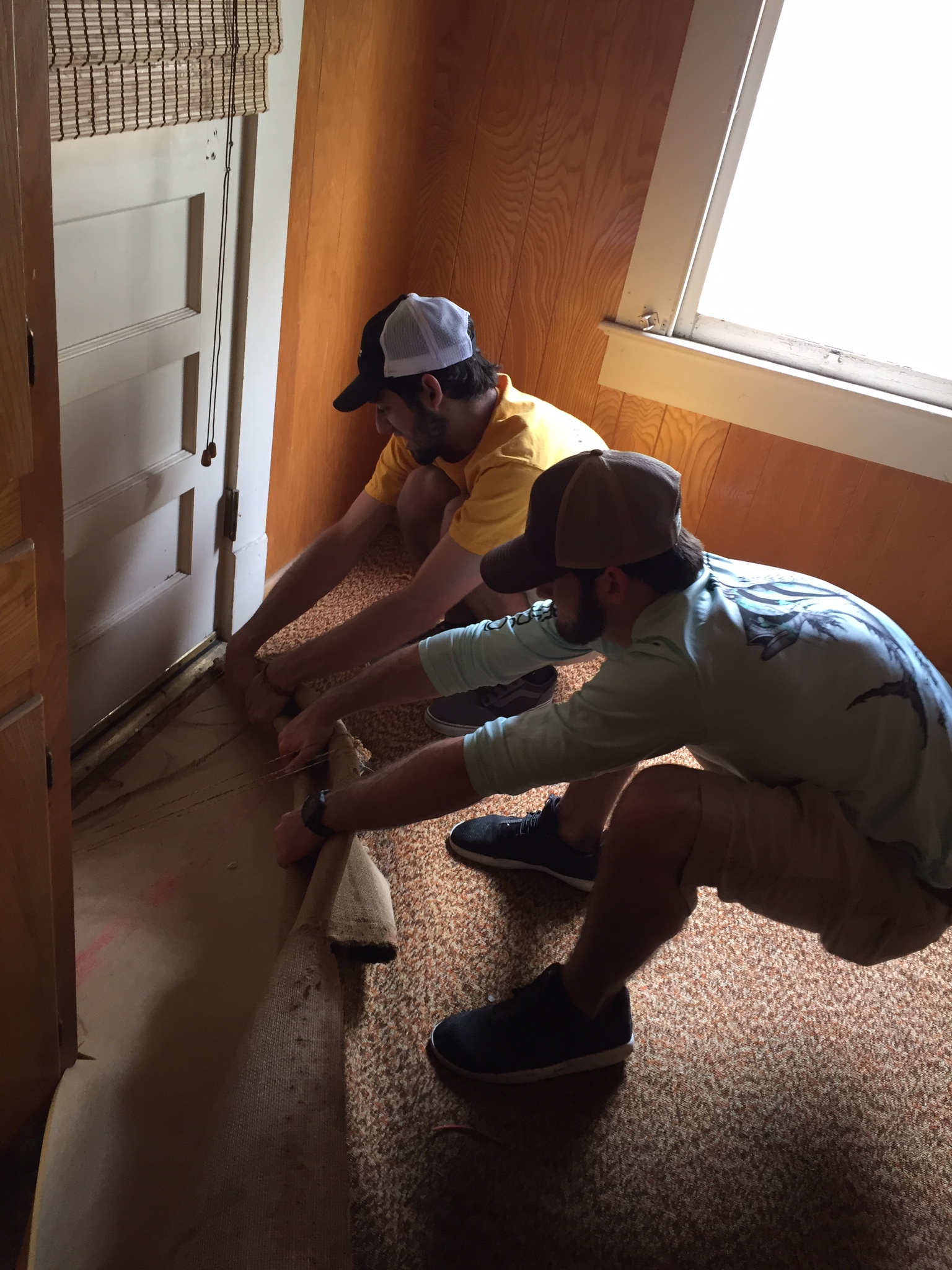 Two Zeta Omega Chapter Members Pulling Up A Carpet Photograph