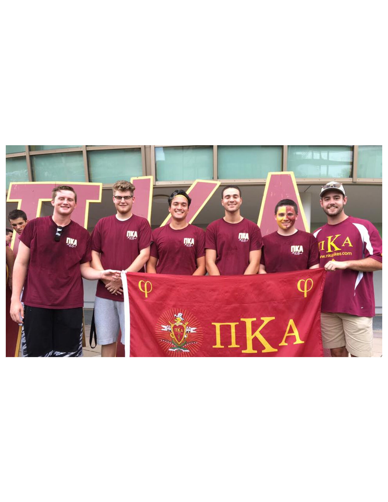 Six Eta Rho Chapter Members Holding A PiKA Flag Photograph