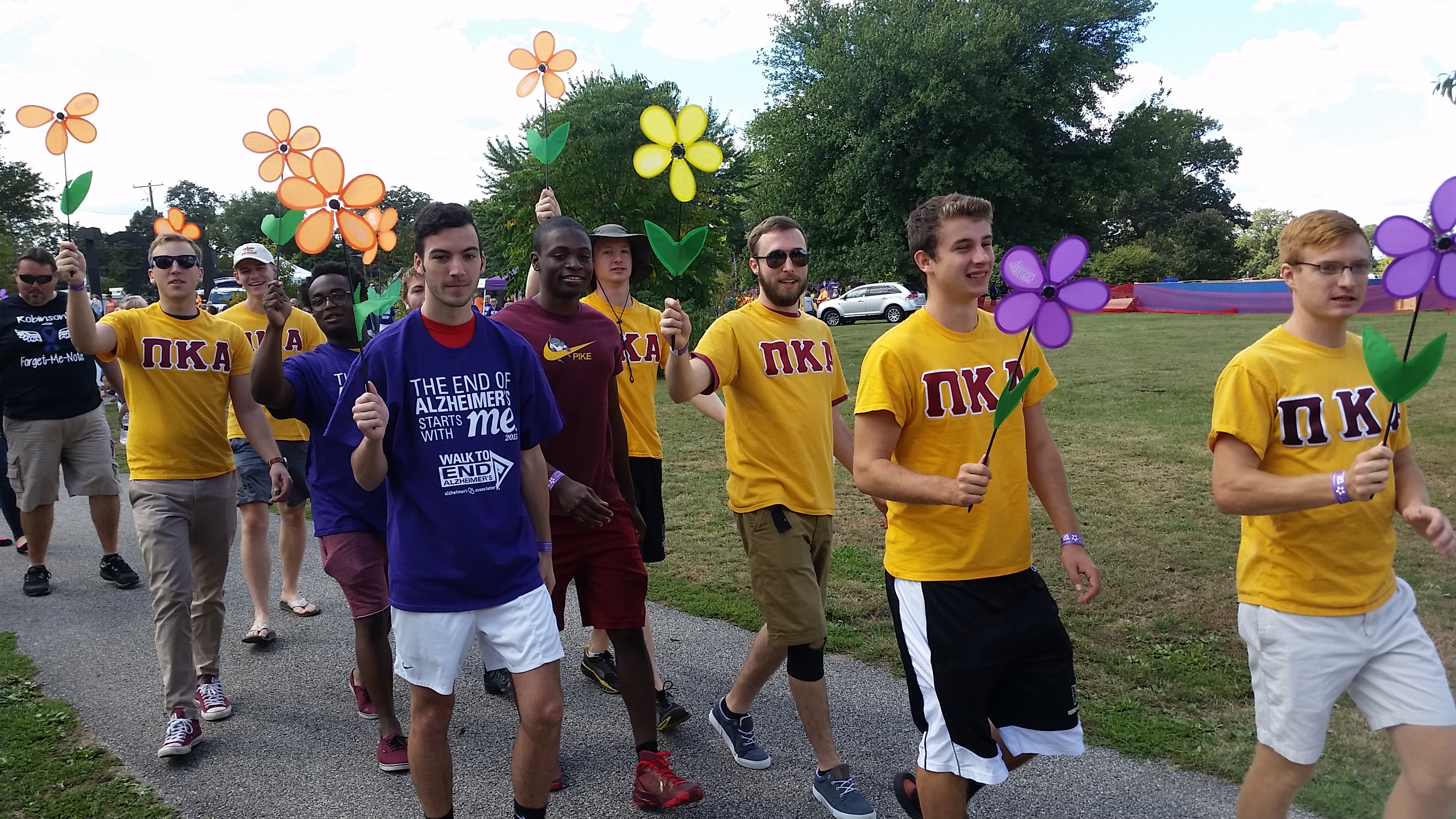 Iota Delta Chapter Members Walking and Holding Flowers Photograph