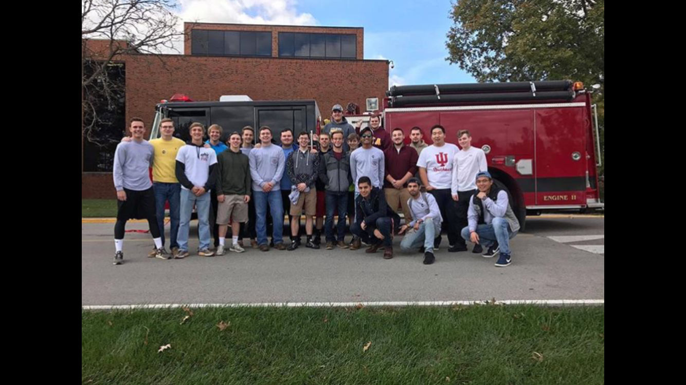 Theta Kappa Chapter Members with a Fire Truck Photograph