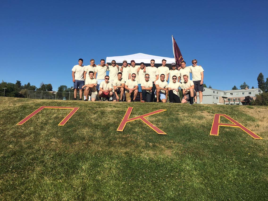 Group Of Zeta Mu Chapter Members Standing Behind Large Greek Letters Photograph