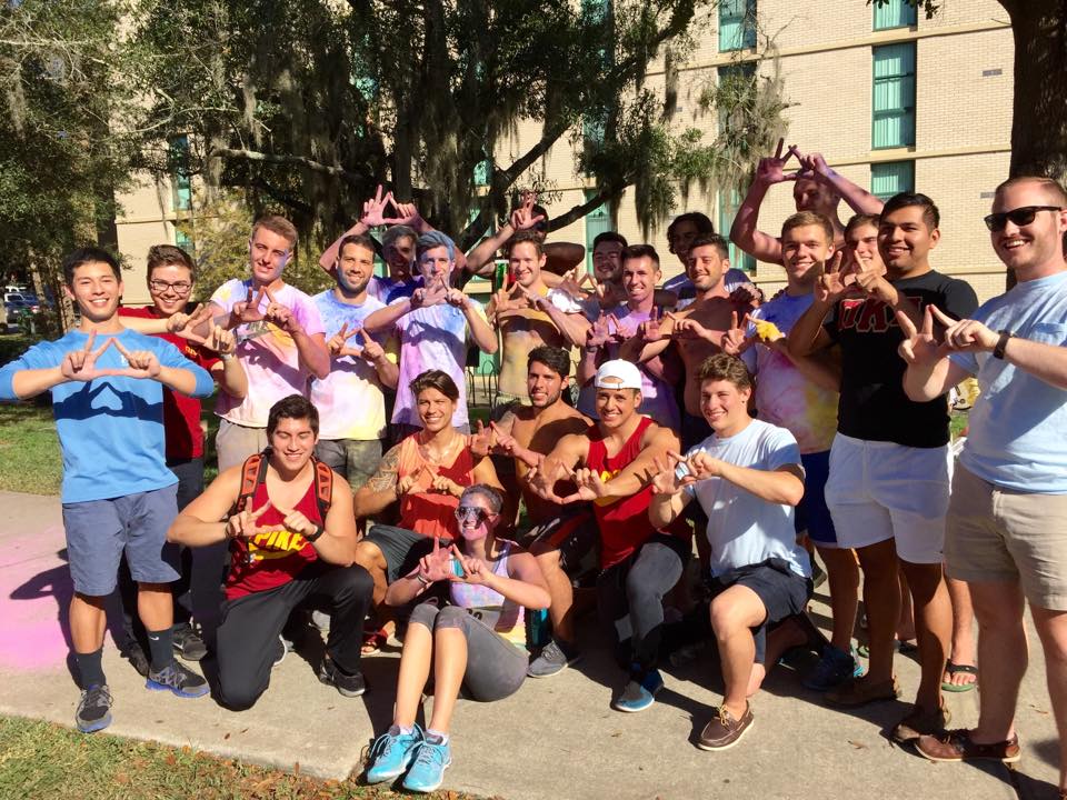 Zeta Pi Chapter Members Form Greek Letters with Their Hands Photograph