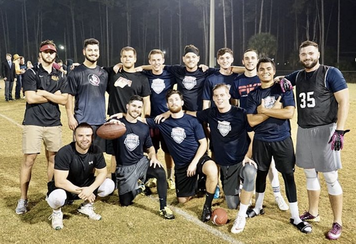 Lambda Xi Chapter Members Playing Football Photograph