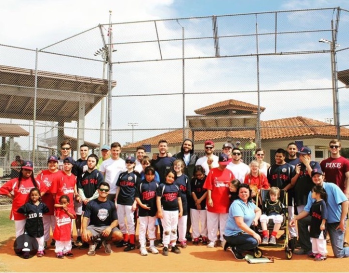 Lambda Xi Chapter Members Play Baseball with Kids Photograph