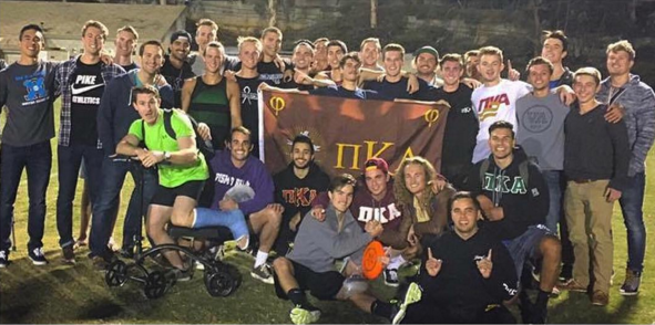 Kappa Phi Chapter Members with a Pi Kappa Alpha Flag Photograph