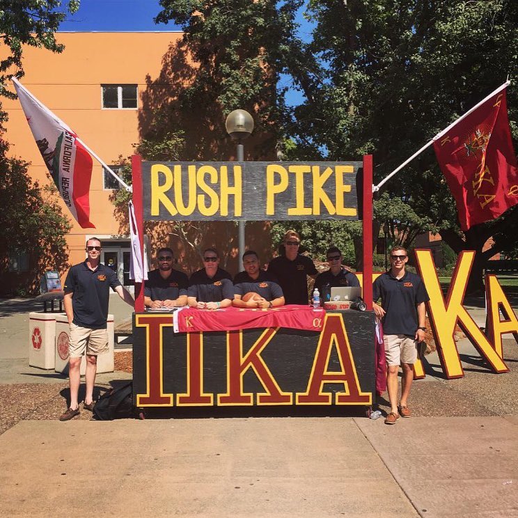 Seven Lambda Psi Chapter Members Run a Rush Pike Booth Photograph