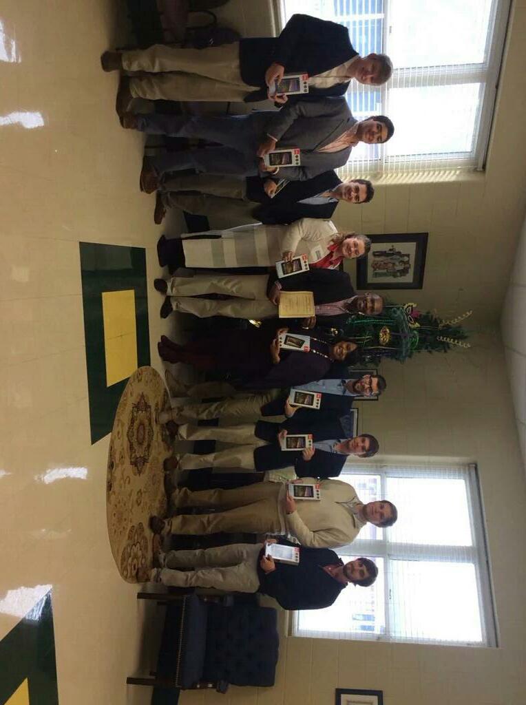 Ten Unidentified Individuals Stand with New Electronics Photograph