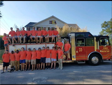 Theta Alpha Chapter Members Around a Fire Truck on Bid Day Photograph