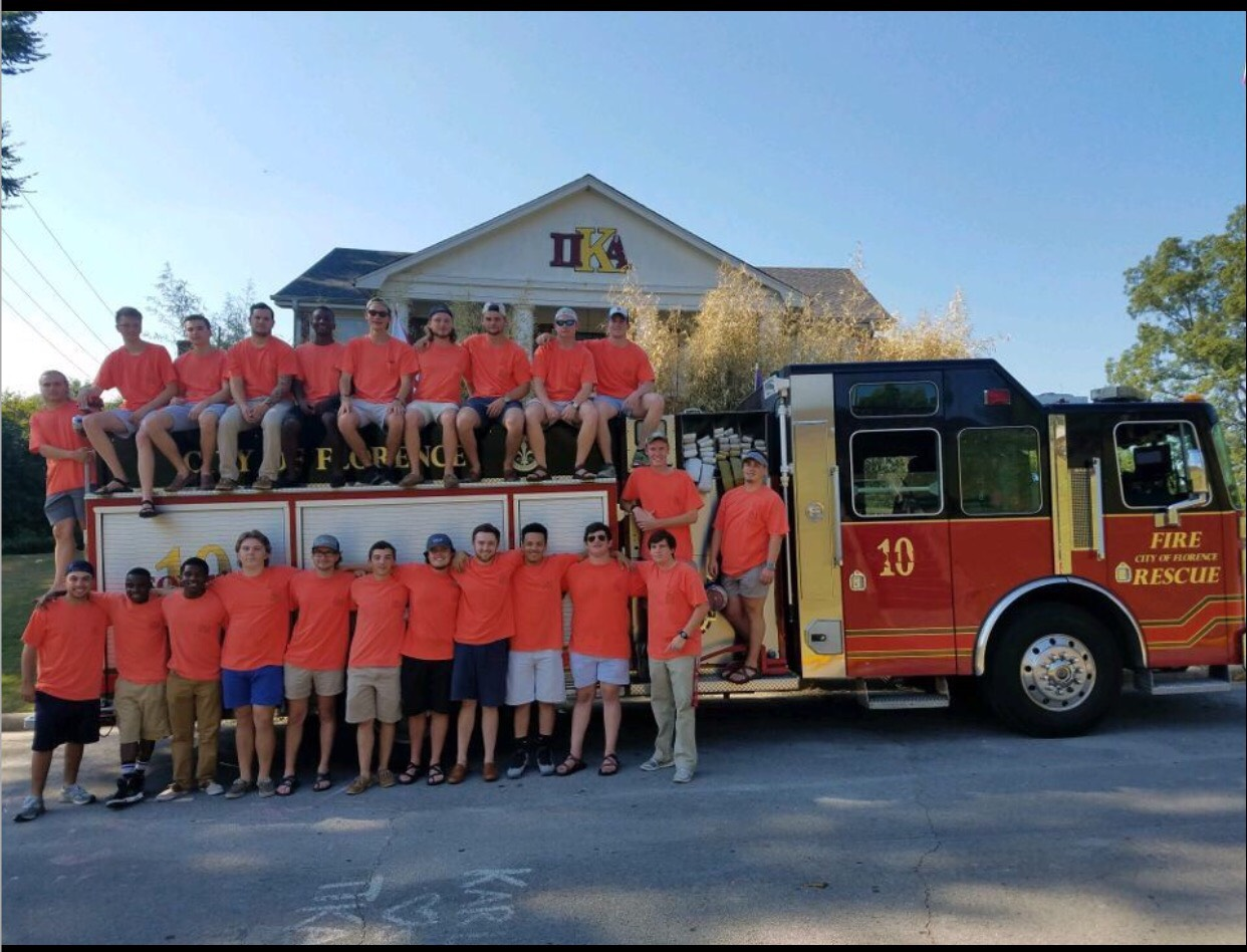 Theta Alpha Chapter Members Around a Fire Truck on Bid Day Photograph