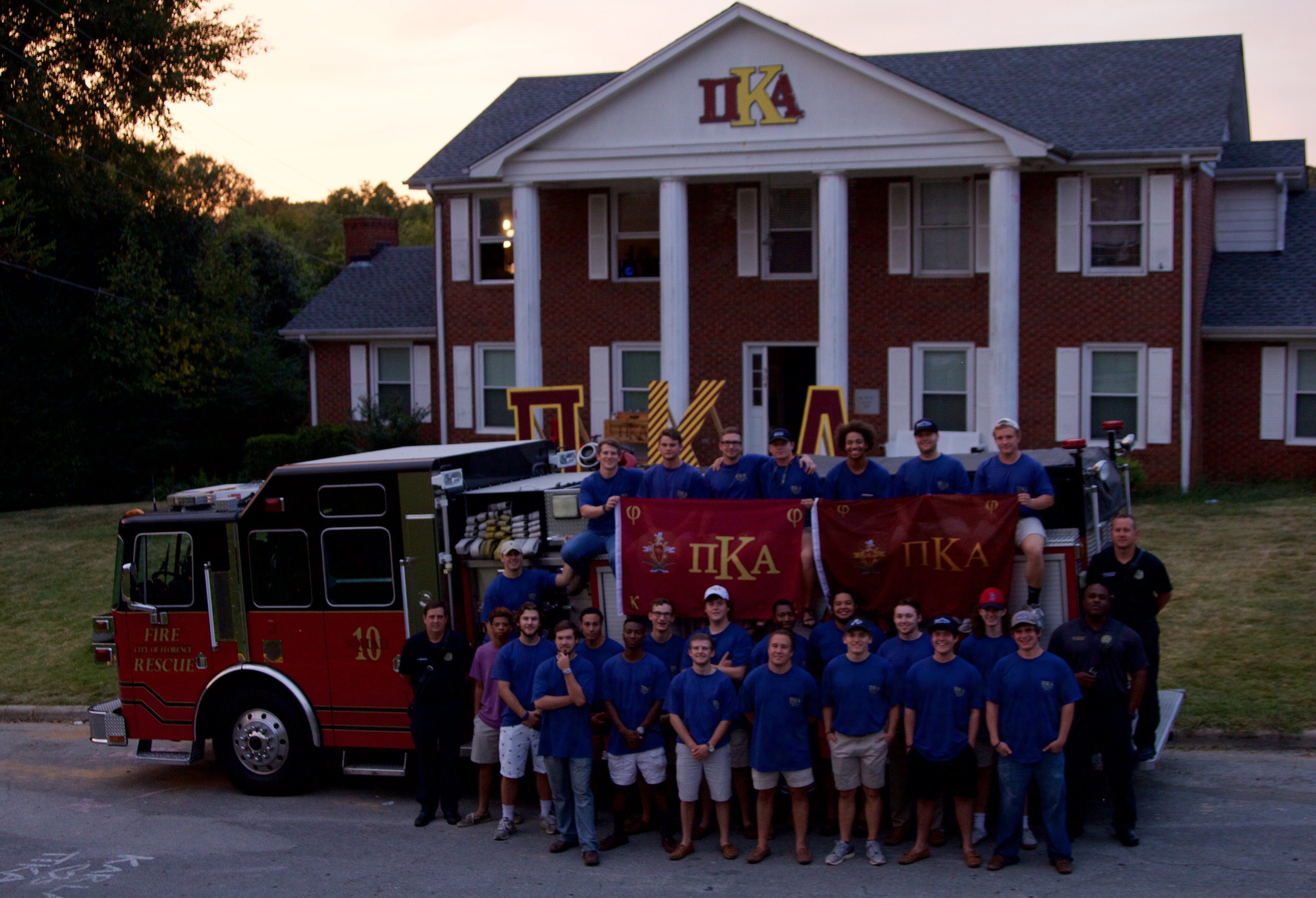 Theta Alpha Chapter Members, a Fire Truck, and Their Chapter House Photograph