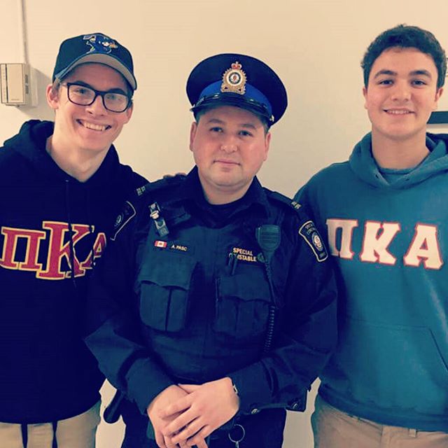 Two Unidentified Kappa Mu Chapter Members with an Officer Photograph