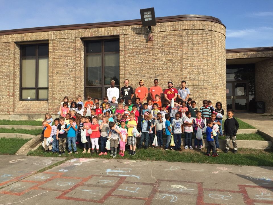 Six Theta Xi Chapter Members Help With An Easter Egg Hunt Photograph