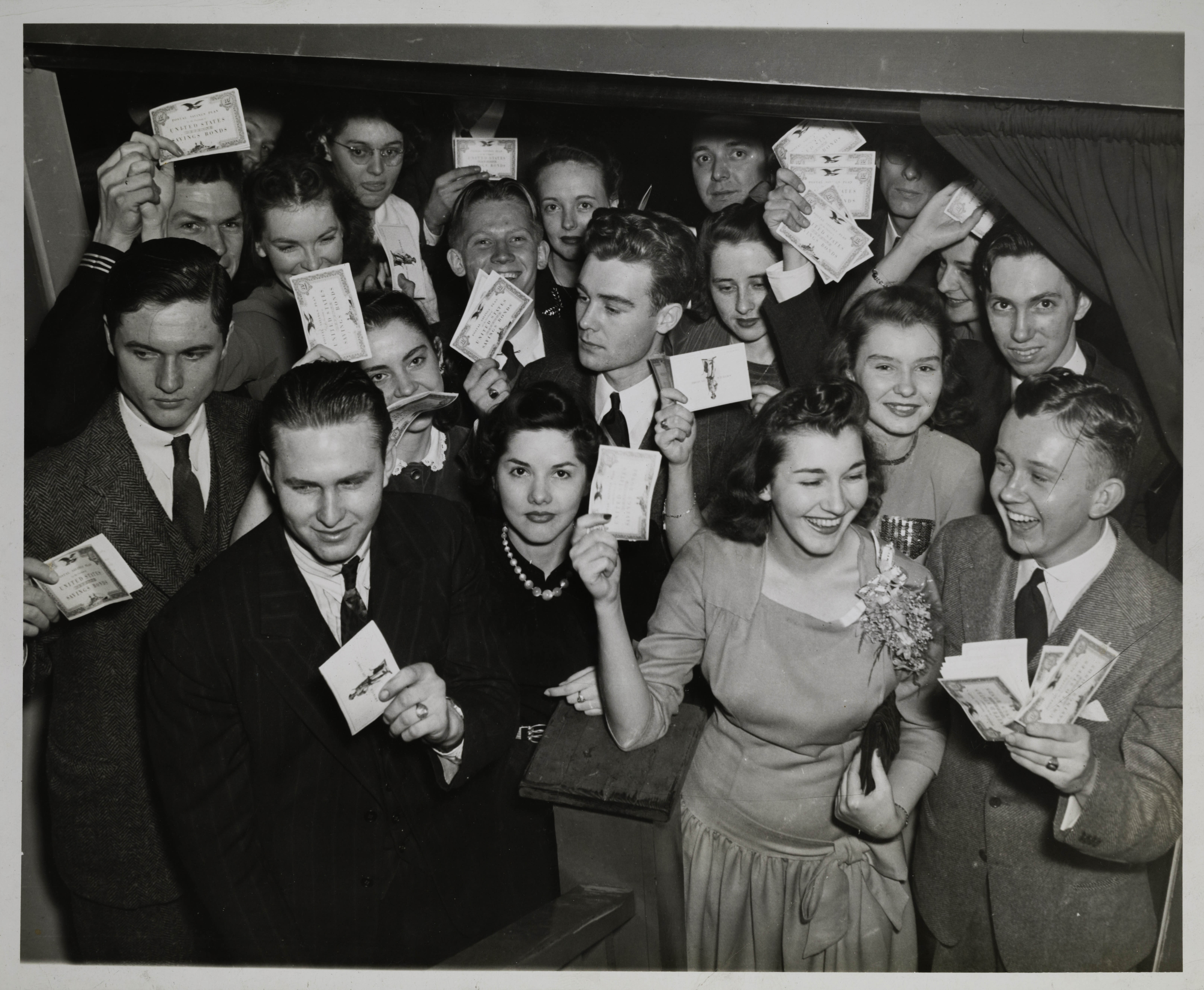 Robert Steele, Katherine Burnham and Unidentified Holding Savings Bonds Books Photograph, c. 1940s