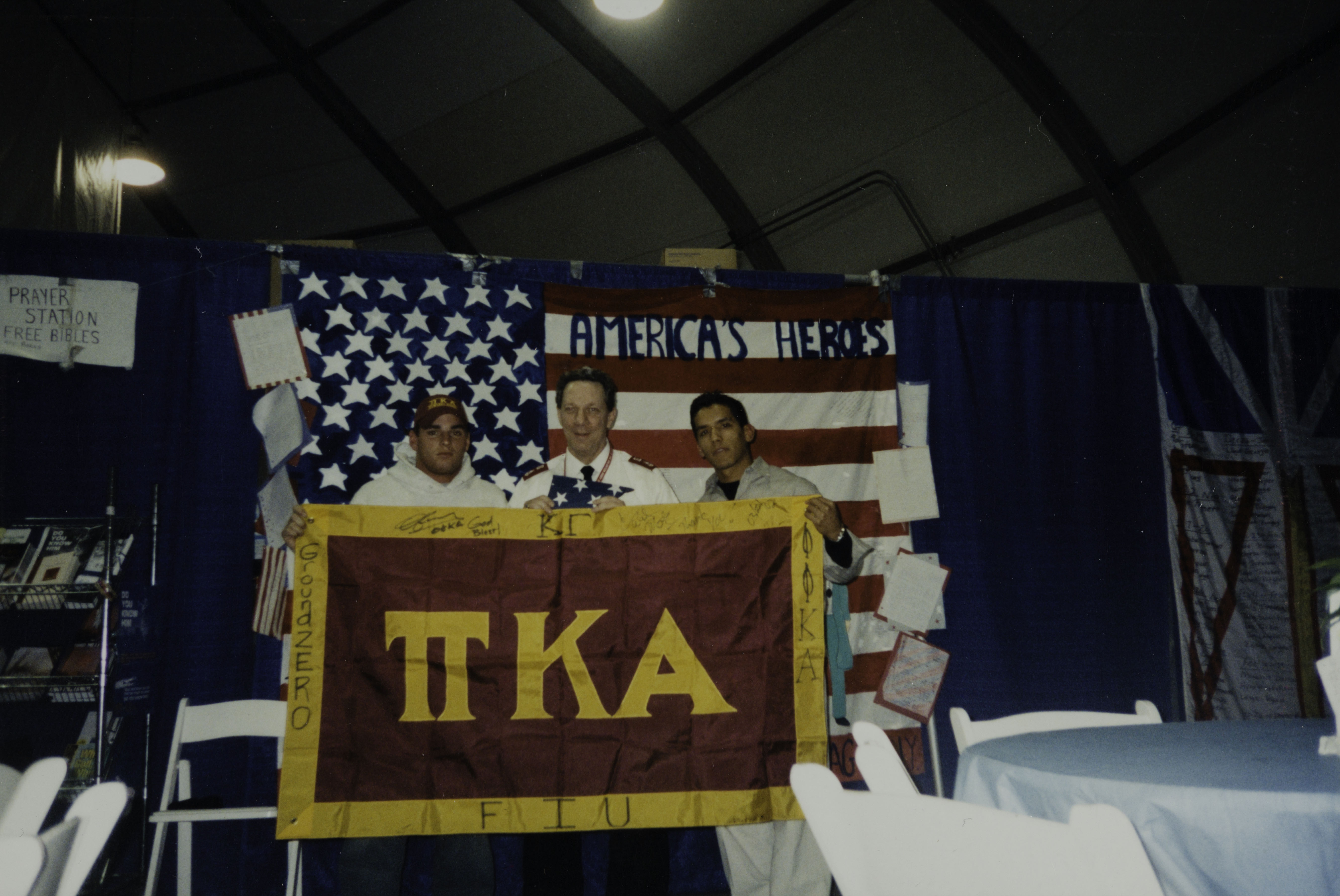 Danny Fernandez and Caleb Mendez Presenting Flag to George Polarek Photograph, 2002
