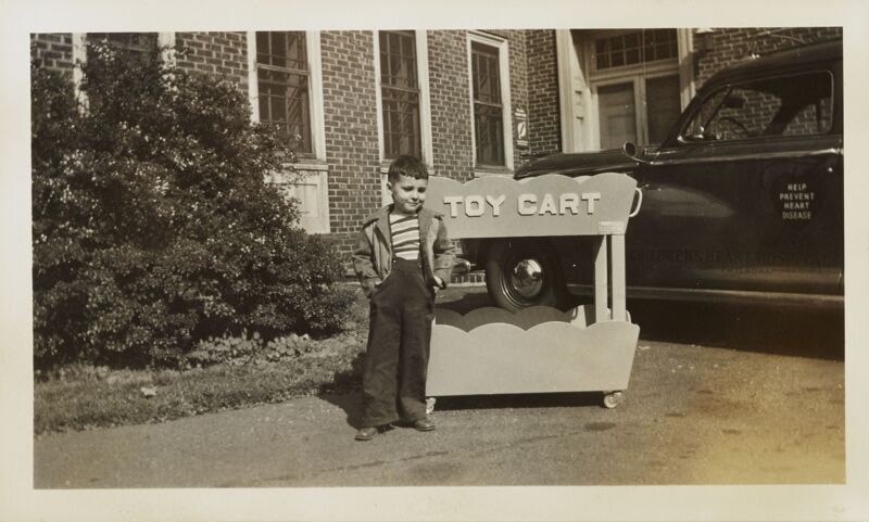 Boy with Toy Cart Outside Children's Heart Hospital Photograph, 1947-48 (Image)