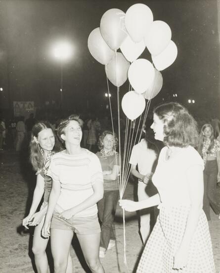 Gamma Lambda Members with Balloons at Campus Carnival Photograph, Spring 1977 (image)