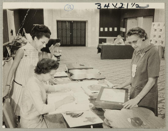 Gilchrist, Riley, and Unidentified at Convention Scrapbook Display Photograph 1, July 7-12, 1968 (image)